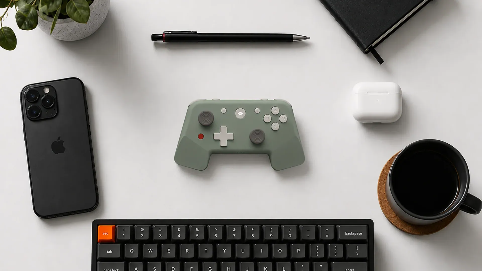 KiteGo controller flat lay with phone, keyboard, earbuds, and coffee